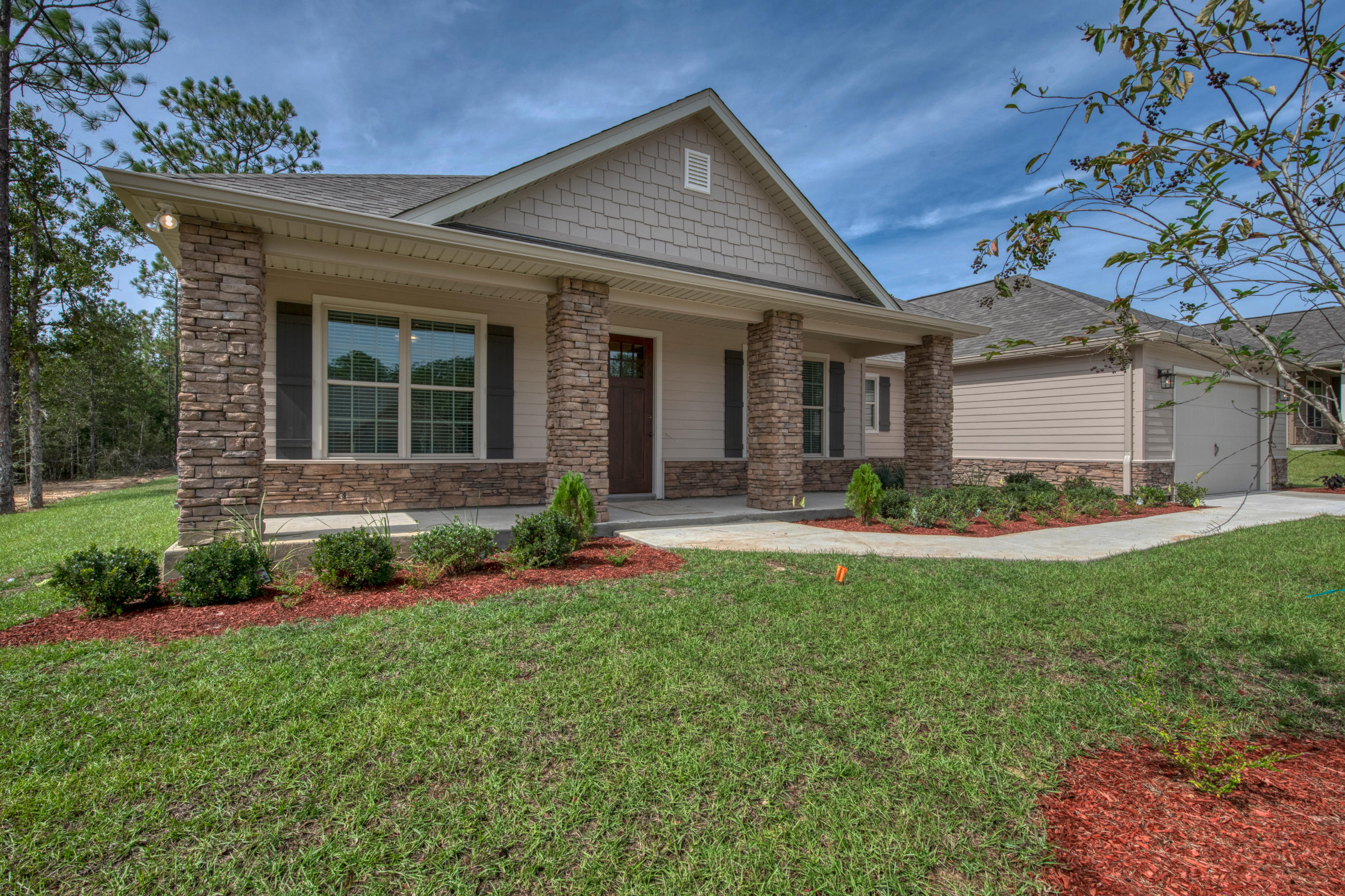 6195 Timberland Ridge Drive Crestview, FL 32539 - Photo 4 of 39 a front view of a house with a yard