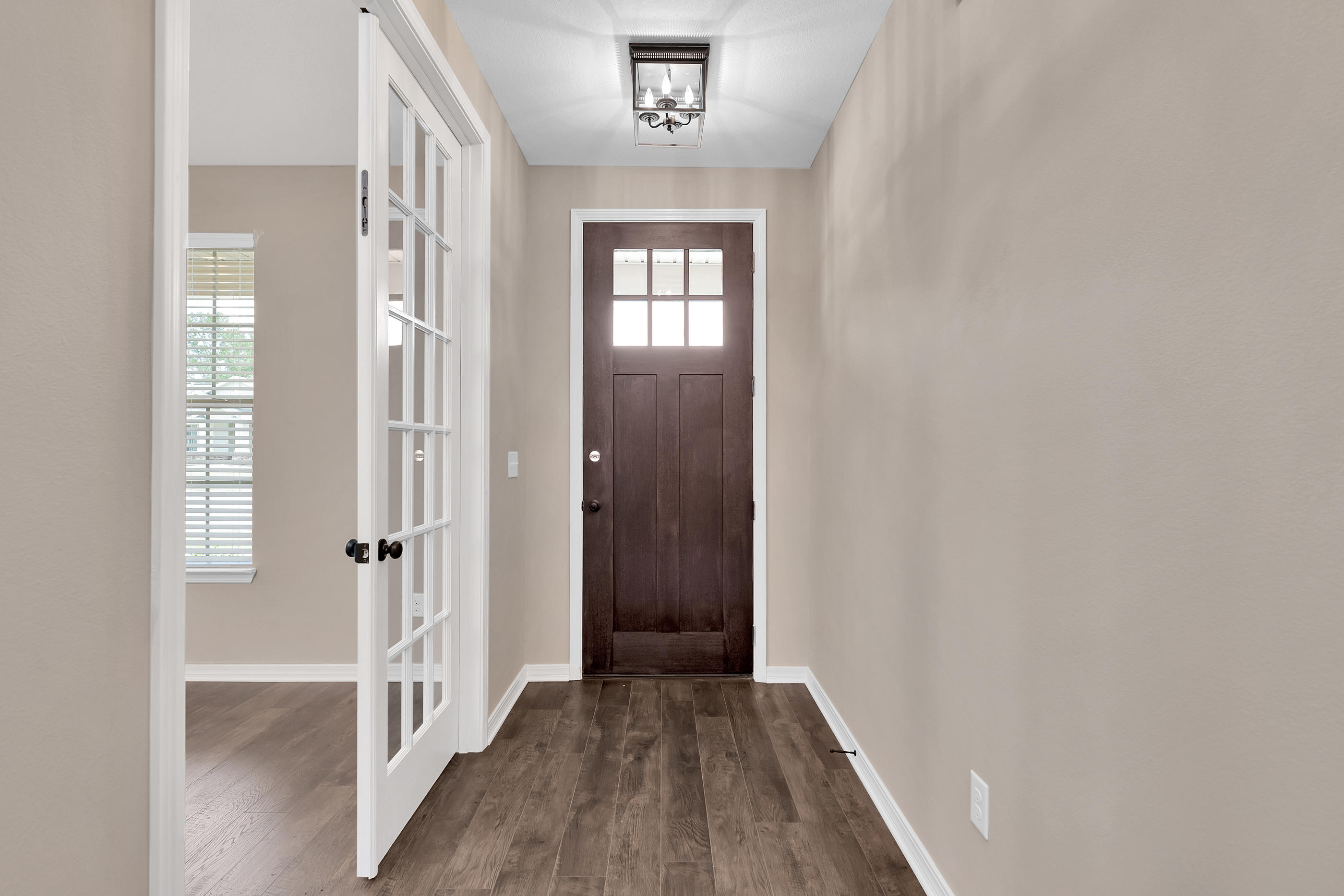 6195 Timberland Ridge Drive Crestview, FL 32539 - Photo 5 of 39 a view of a hallway with wooden floor and a window