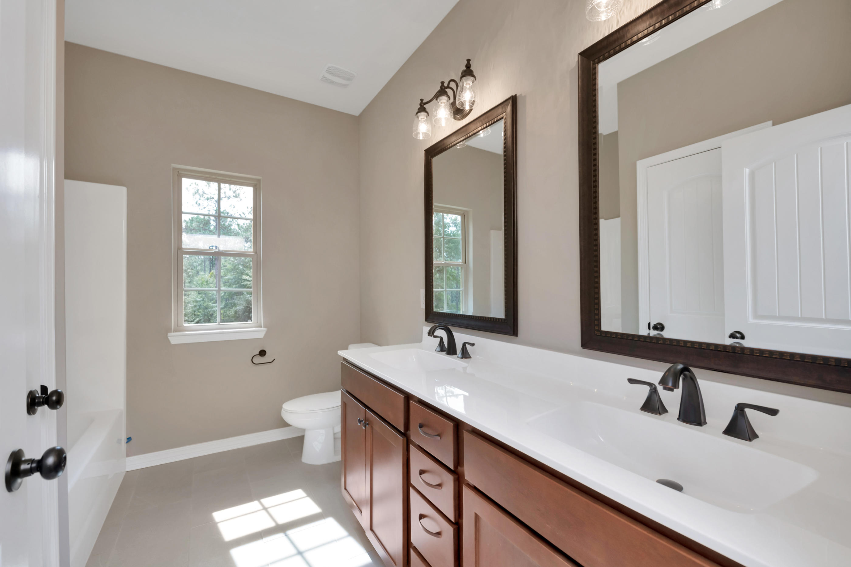 6195 Timberland Ridge Drive Crestview, FL 32539 - Photo 8 of 39 a bathroom with a sink a toilet and a mirror