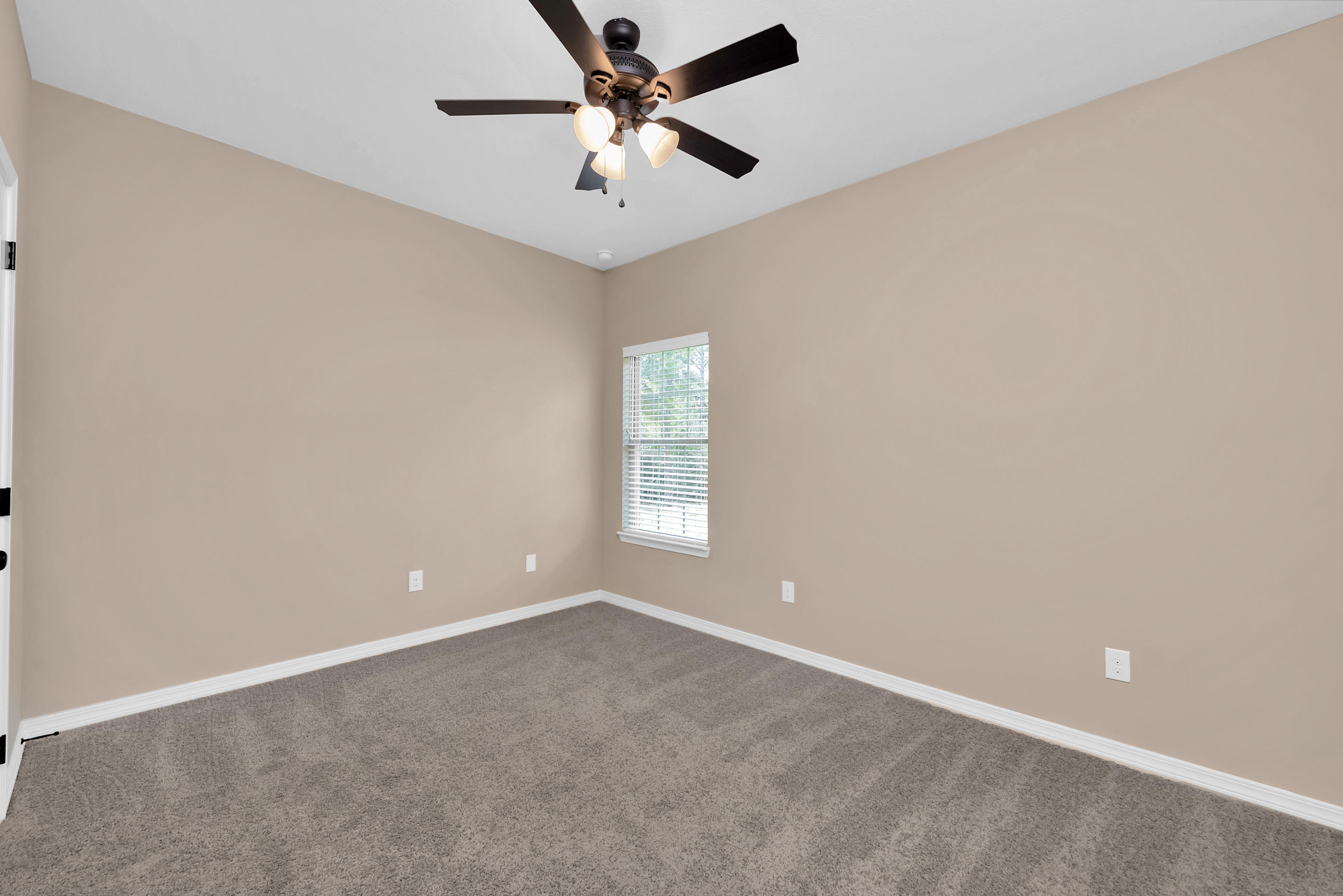 6195 Timberland Ridge Drive Crestview, FL 32539 - Photo 9 of 39 an empty room with windows and fan
