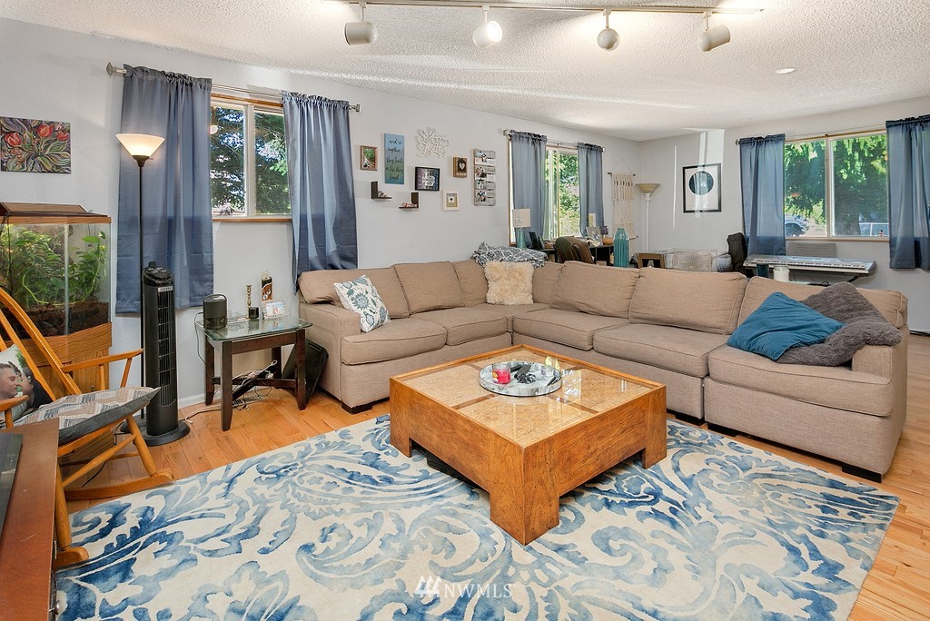 12008 Gibson Road Everett, WA 98204 - Photo 12 of 32 a living room with furniture a rug and a large window