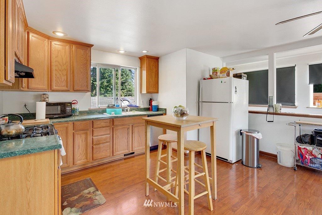 12008 Gibson Road Everett, WA 98204 - Photo 24 of 32 a kitchen with wooden floors and appliances