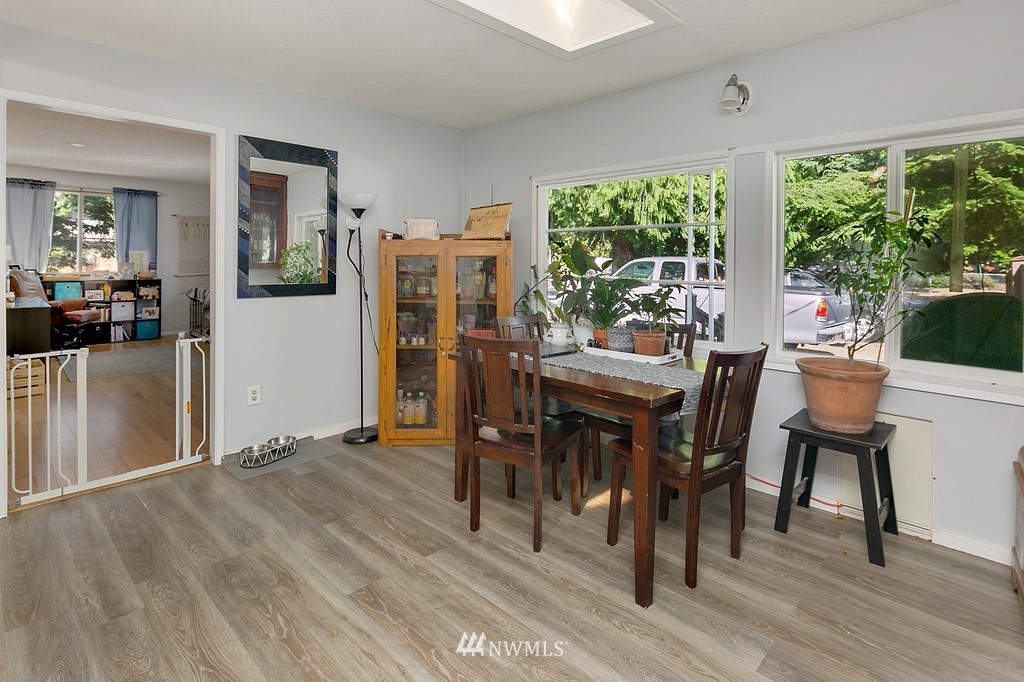 12008 Gibson Road Everett, WA 98204 - Photo 9 of 32 a view of a dining room with furniture and wooden floor