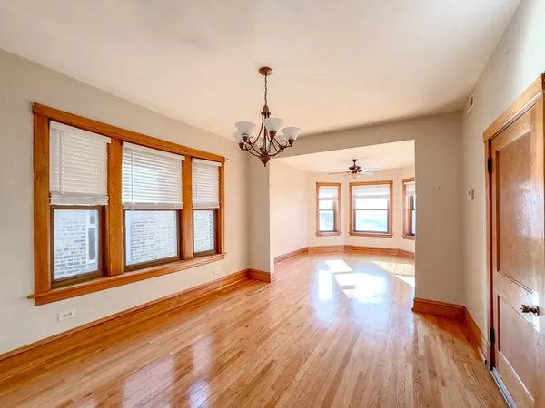 a view of livingroom with an entryway and wooden floor