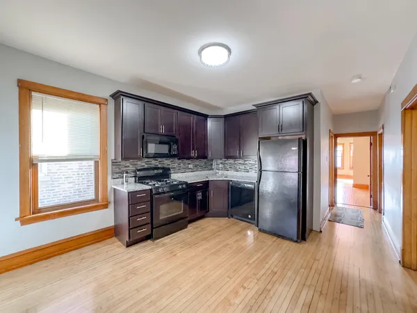 a kitchen with stainless steel appliances granite countertop a refrigerator stove and sink