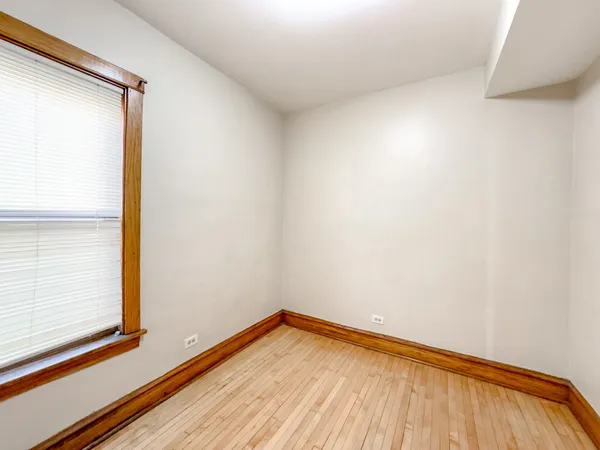 a view of a room with wooden floor and a window