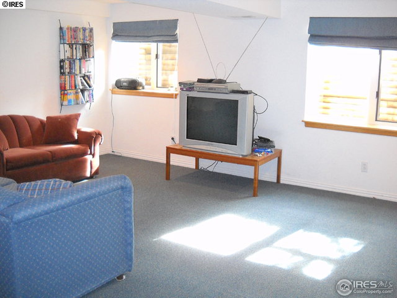 3172 Redstone Road Boulder, CO 80305 - Photo 21 of 24 a living room with furniture a window and a flat screen tv