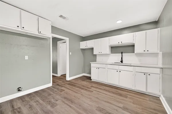 a kitchen with granite countertop white cabinets and white appliances