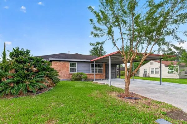 a house that has a tree in front of it