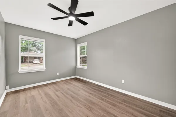 wooden floor in an empty room with a window