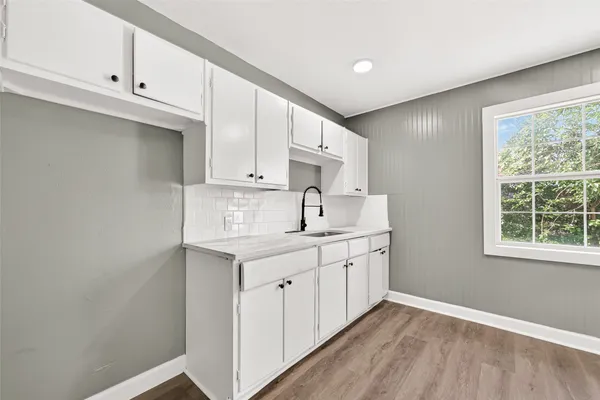 a kitchen with a sink cabinets and window