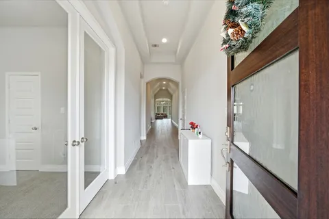 a living room with furniture fireplace and large windows