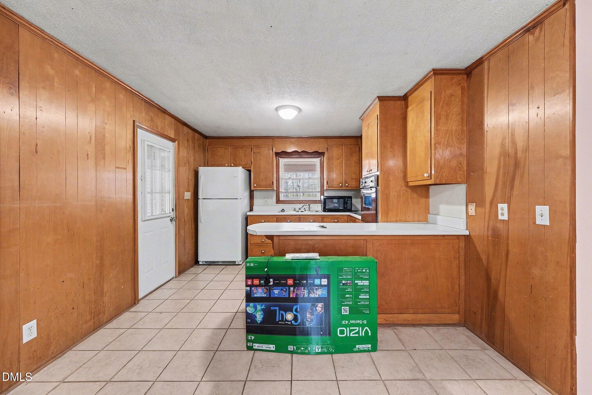 3312 Hamlin Road Durham, NC 27704 - Photo 10 of 37 a kitchen with stainless steel appliances granite countertop a refrigerator and a stove