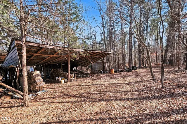 a view of an empty room with wooden floor and closet