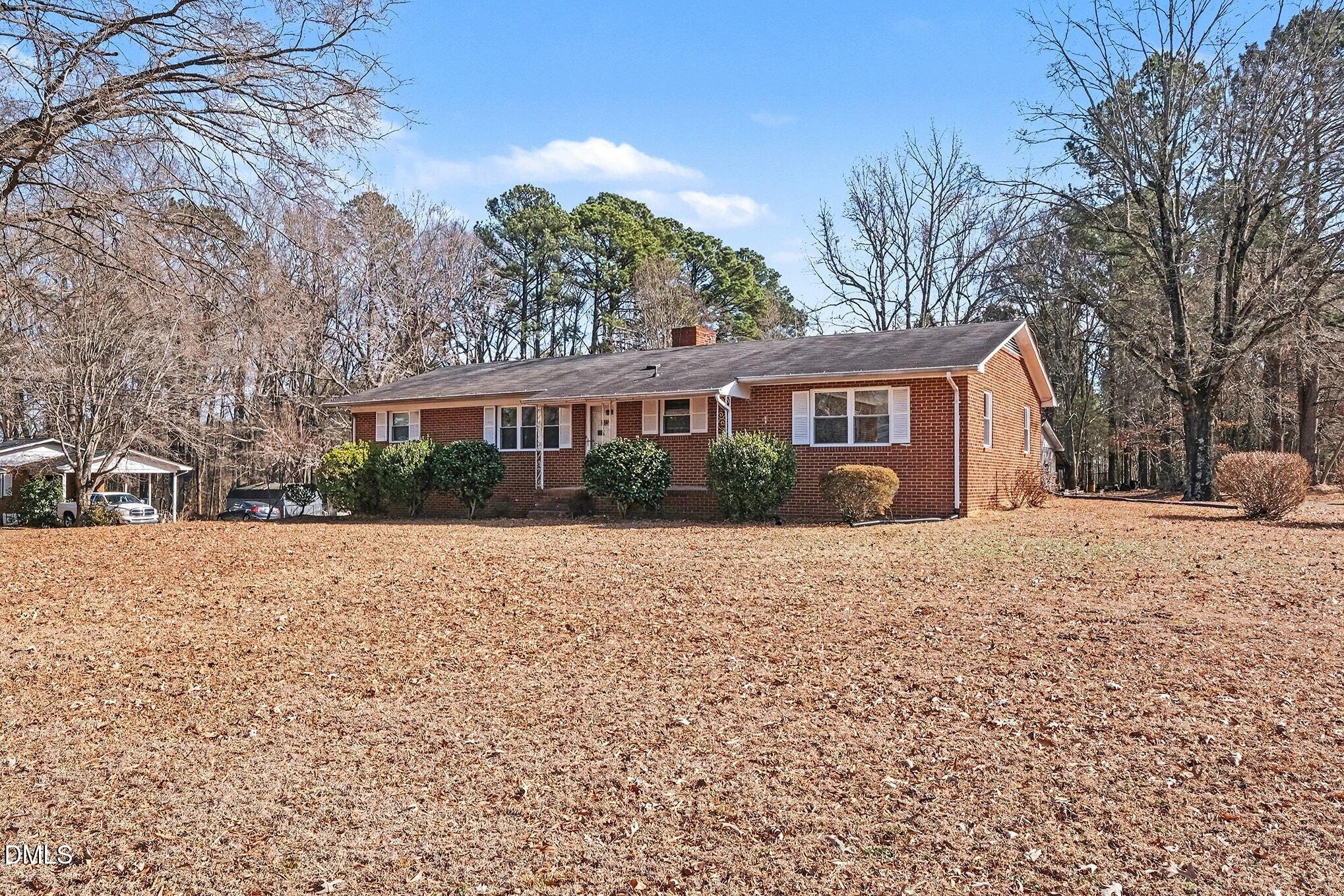 3312 Hamlin Road Durham, NC 27704 - Photo 5 of 37 a front view of a house with a yard and garage