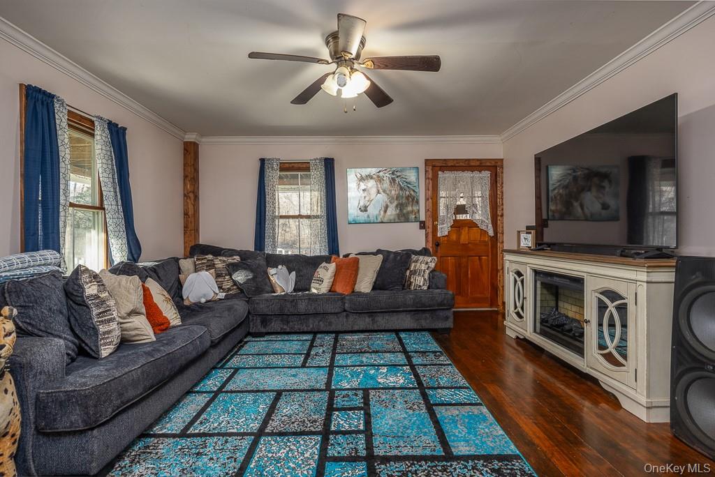 355 Fosler Road Wallkill, NY 12589 - Photo 11 of 33 Living room featuring ornamental molding, dark wood-style flooring, and a ceiling fan