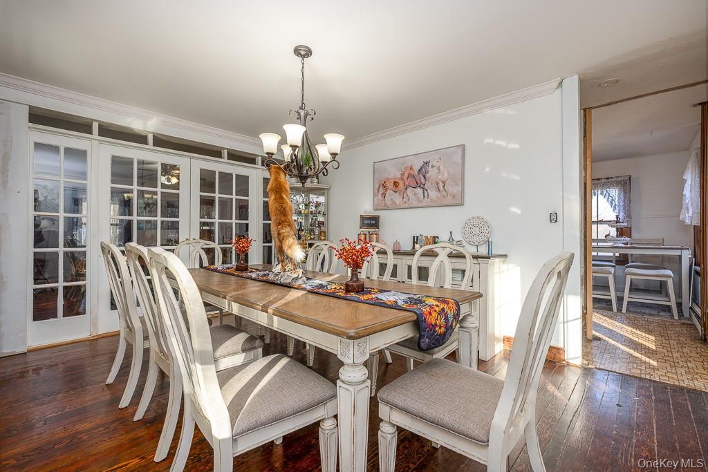 355 Fosler Road Wallkill, NY 12589 - Photo 9 of 33 Dining space with dark wood-type flooring, a chandelier, and crown molding