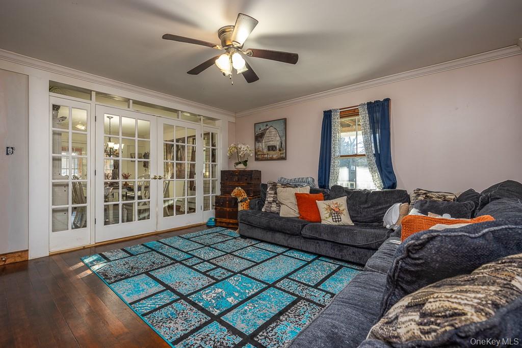 355 Fosler Road Wallkill, NY 12589 - Photo 10 of 33 Living area with french doors, ornamental molding, a ceiling fan, and dark wood-type flooring