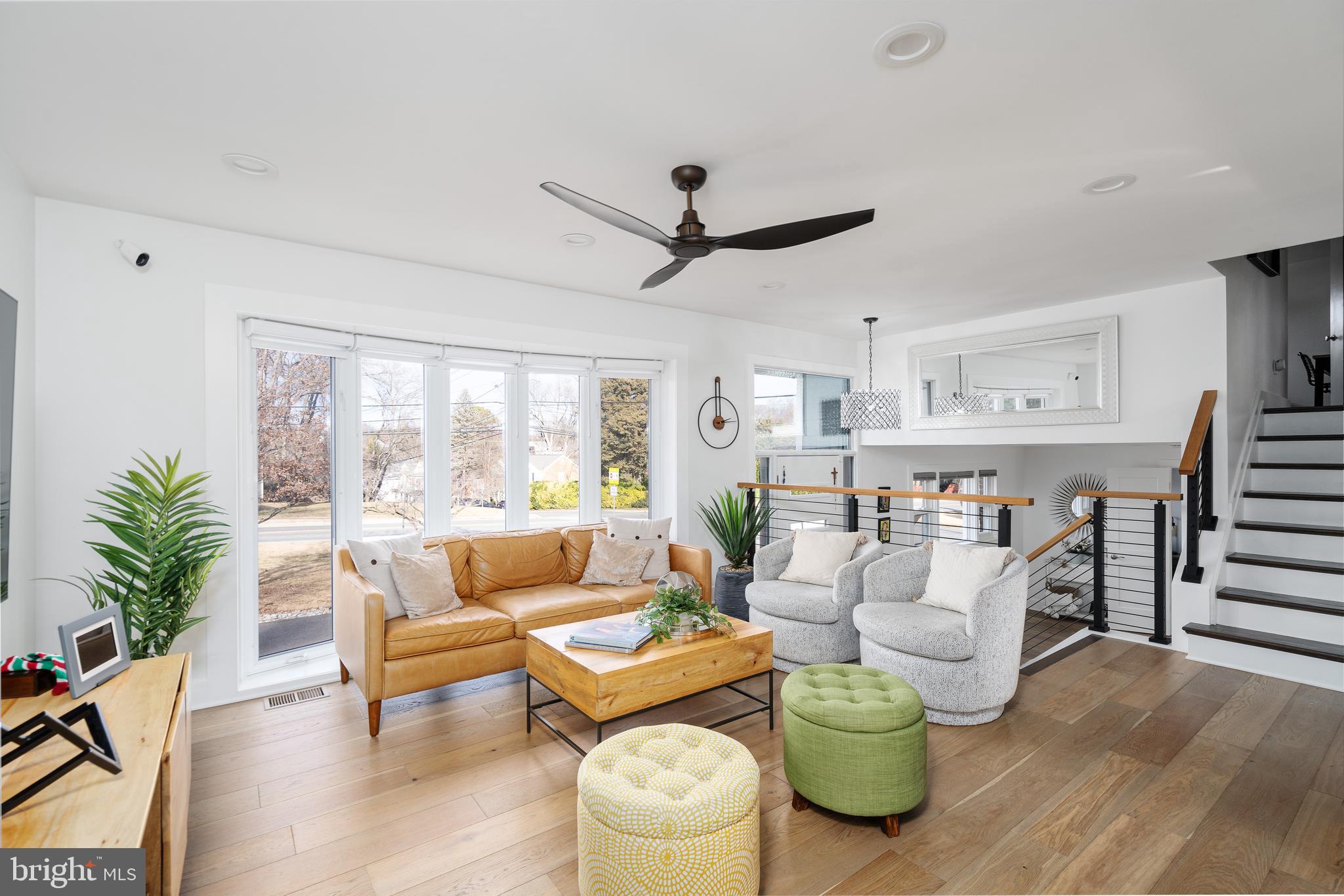 6100 Greentree Road Bethesda, MD 20817 - Photo 4 of 39 a living room with furniture a ceiling fan and a large window