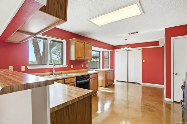 a kitchen with stainless steel appliances granite countertop a sink and a stove