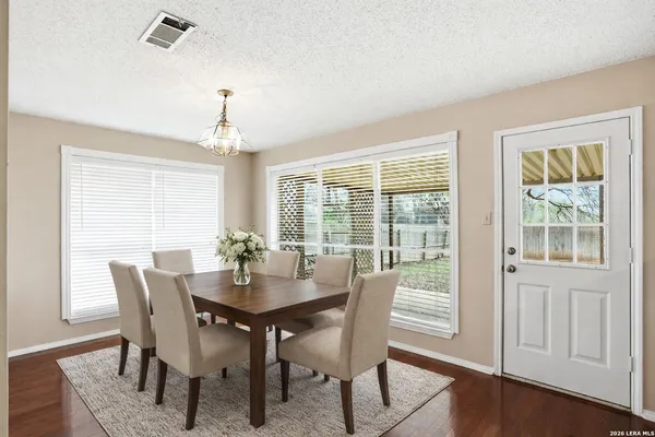 a view of a dining room with furniture window and wooden floor