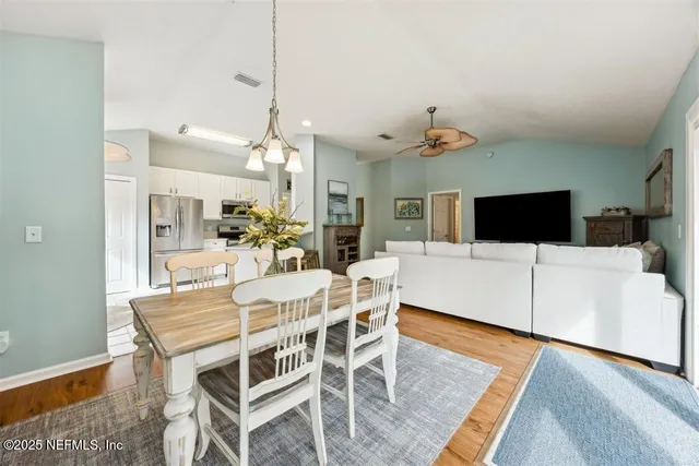 a view of a dining room with furniture and wooden floor