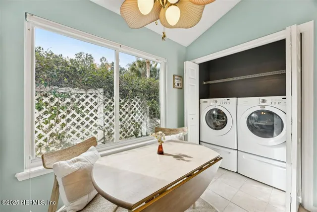 a living room with a large window with table and chairs