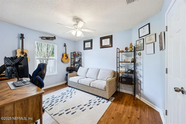 a living room with furniture a rug and white walls
