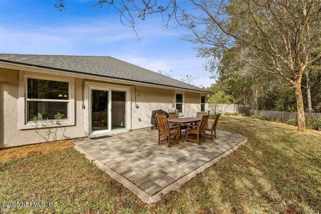 a swimming pool with outdoor seating and yard