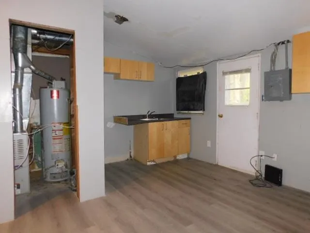 a view of a livingroom with wooden floor and a flat screen tv