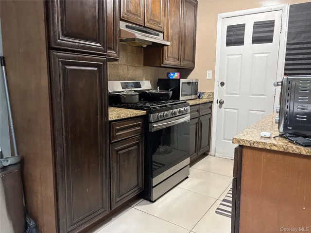 a kitchen with stainless steel appliances granite countertop a stove and a refrigerator