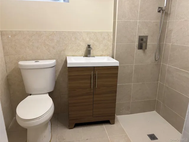 a bathroom with a sink a toilet and a shower
