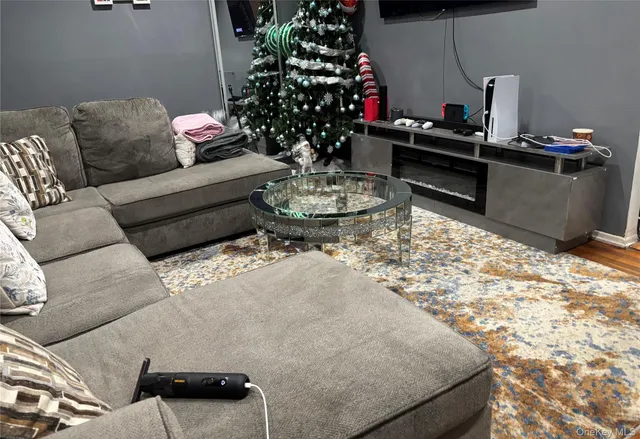 a living room with furniture and flowers