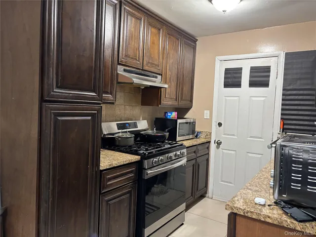a kitchen with a stove and a microwave