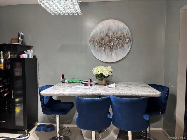 a dining room with furniture and chandelier
