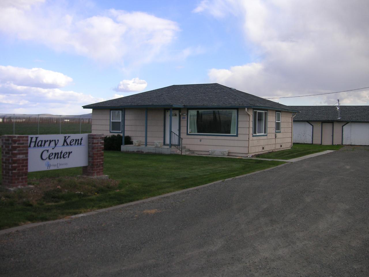 a front view of a house with a garden and yard