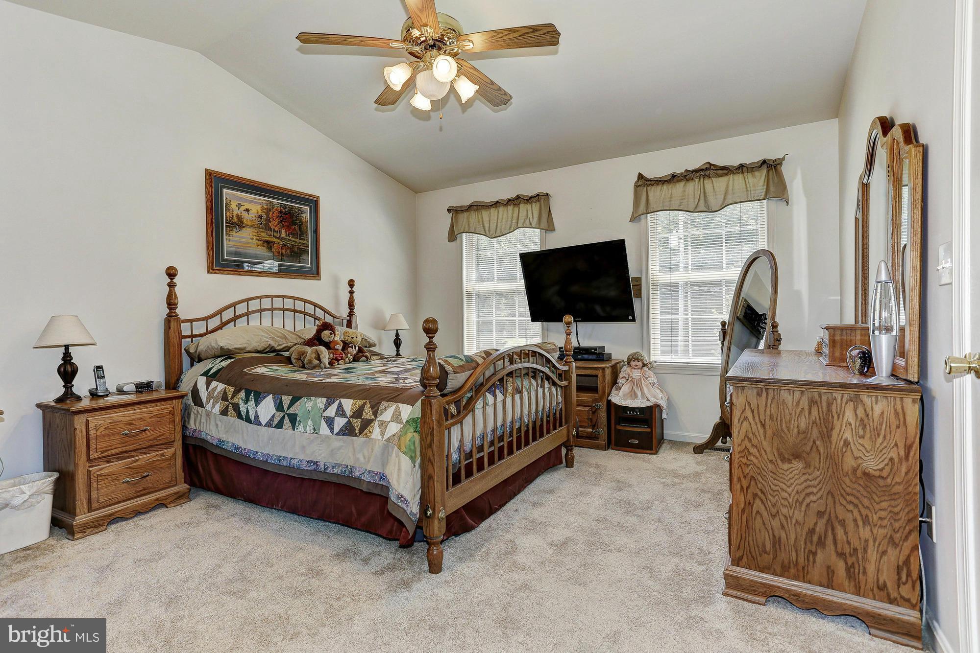 506 Ridge Road Finksburg, MD 21048 - Photo 13 of 30 a bedroom with a bed and a flat screen tv