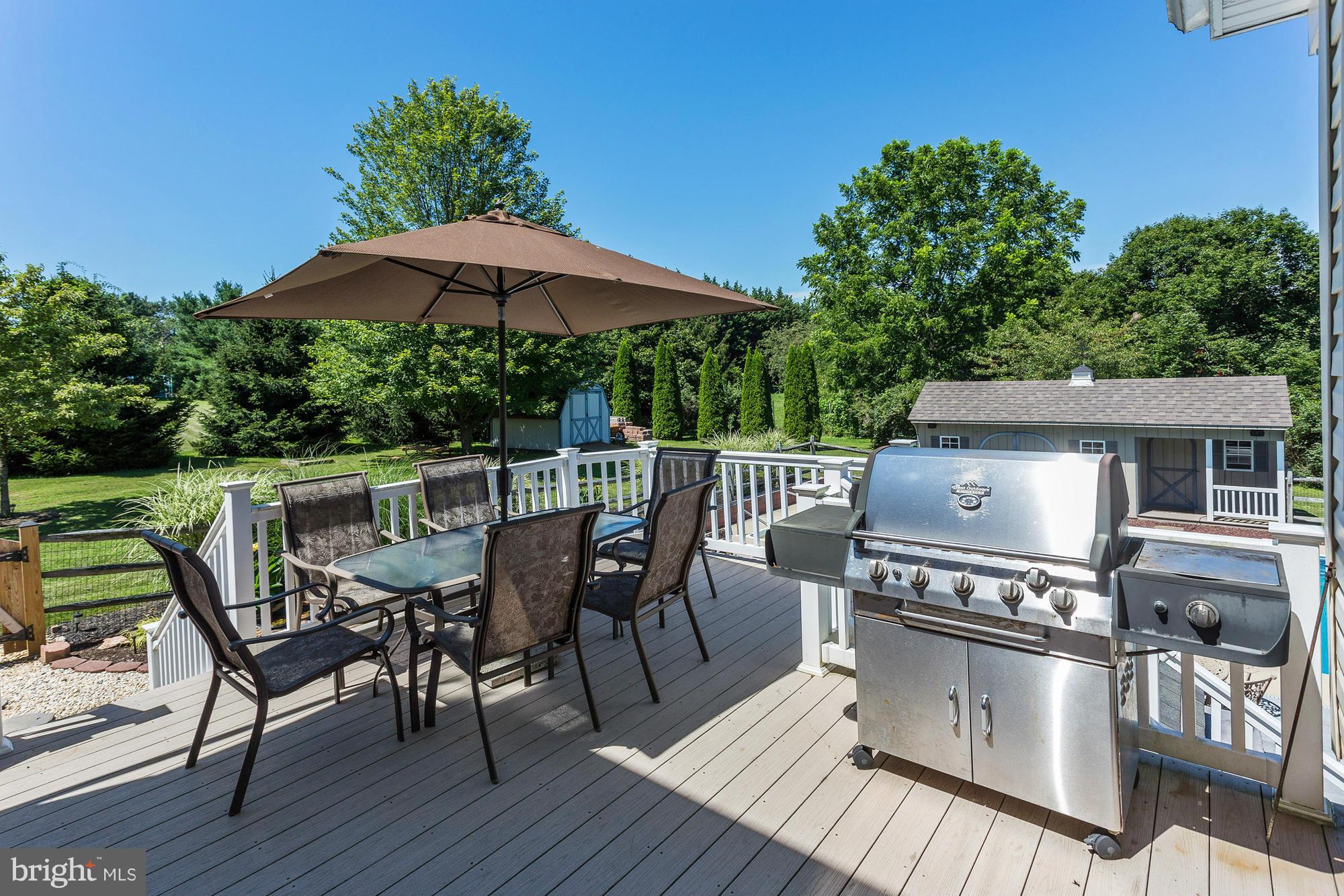 506 Ridge Road Finksburg, MD 21048 - Photo 28 of 30 a view of a roof deck with table and chairs under an umbrella with wooden floor
