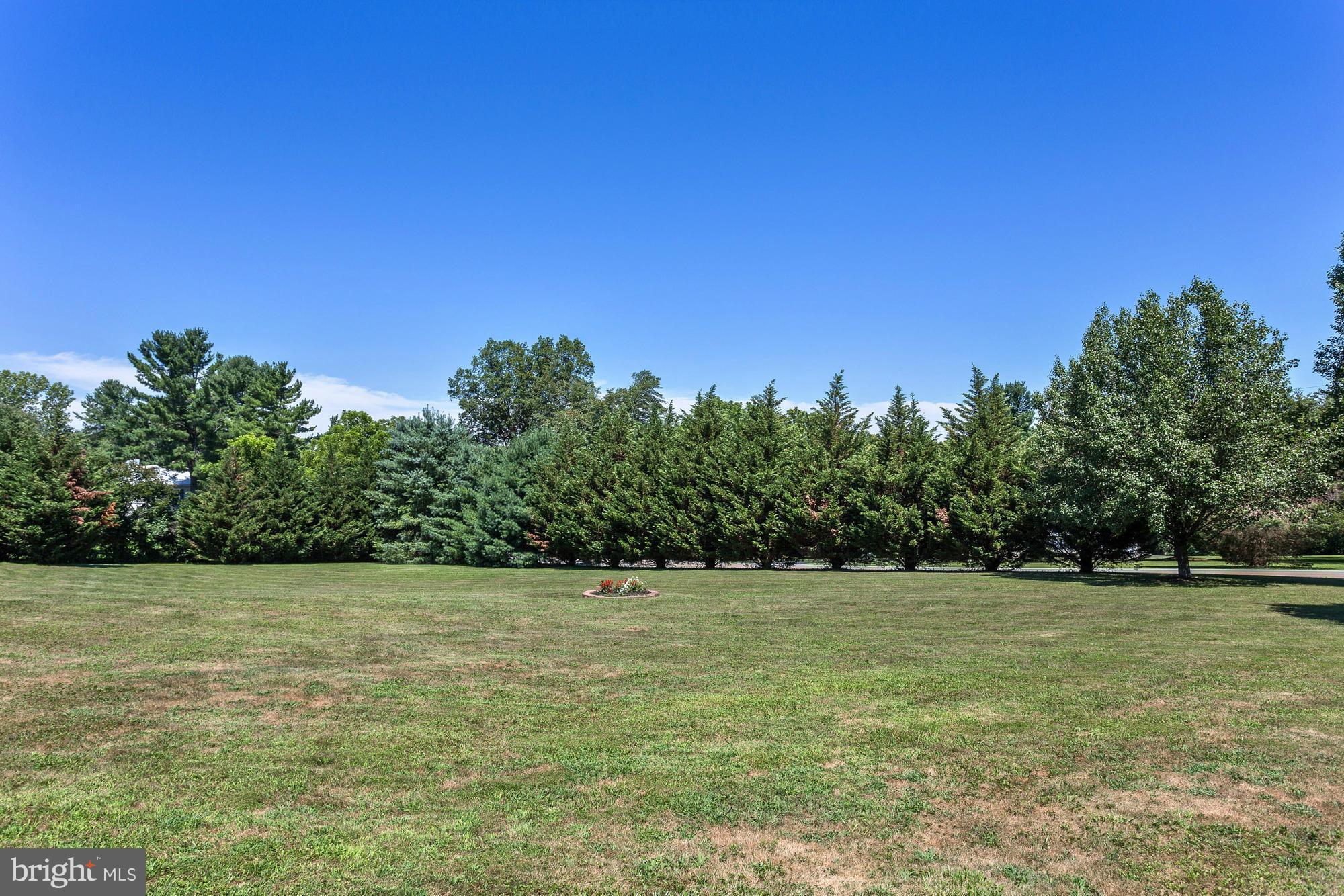 506 Ridge Road Finksburg, MD 21048 - Photo 29 of 30 a view of a grassy field with trees in the background
