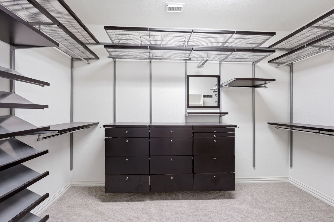 315 Arbor Ridge Lane Conroe, TX 77384 - Photo 23 of 47 The primary closet with custom shelving is a showstopper!!