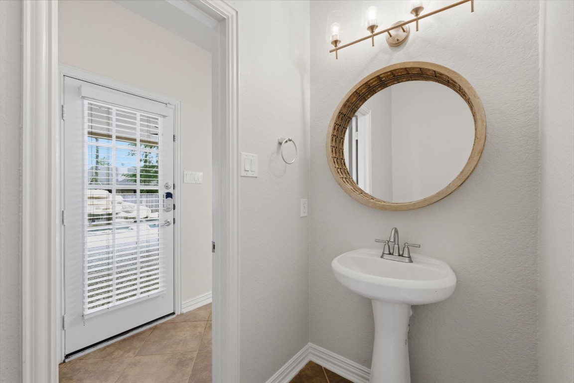 315 Arbor Ridge Lane Conroe, TX 77384 - Photo 24 of 47 The attractive downstairs powder room is tucked away and easily accessible from the back patio.