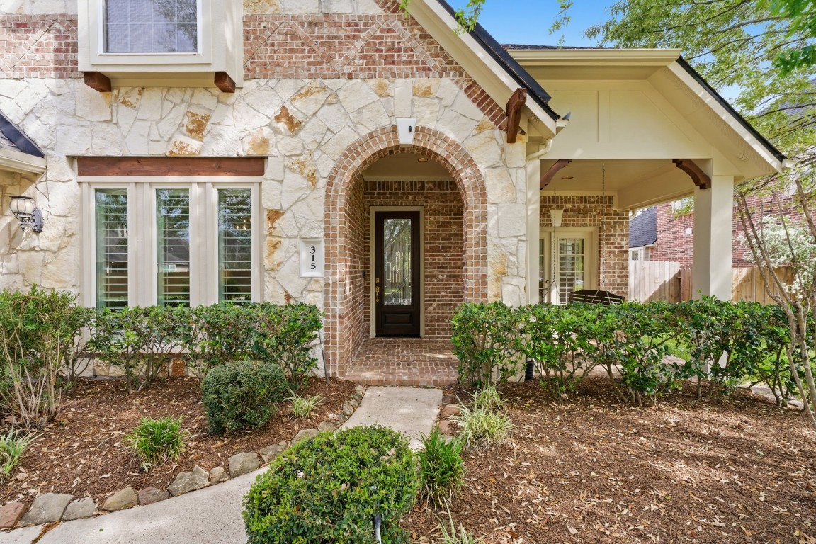 315 Arbor Ridge Lane Conroe, TX 77384 - Photo 3 of 47 The inviting porch with a swing welcomes friends and family.