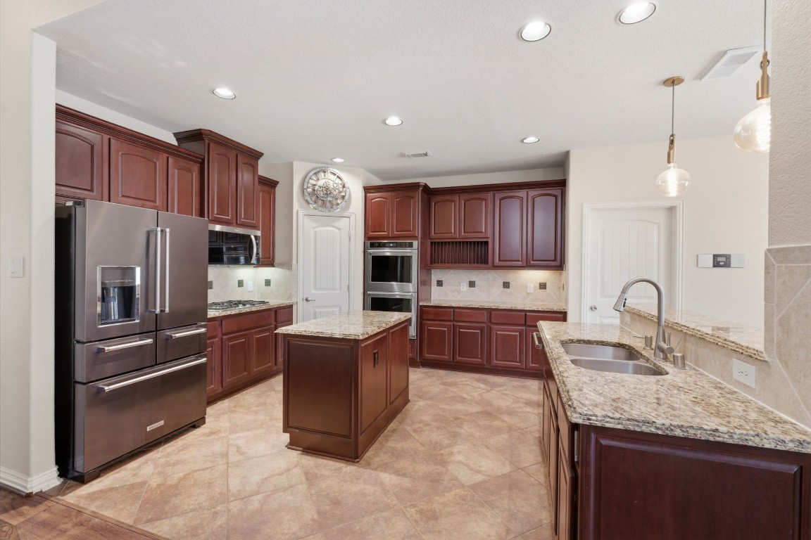 315 Arbor Ridge Lane Conroe, TX 77384 - Photo 8 of 47 So many touches that make this kitchen perfect - tons of storage, newer appliances, double oven, prep island, large pantry, bar seating, and fridge that can be included.