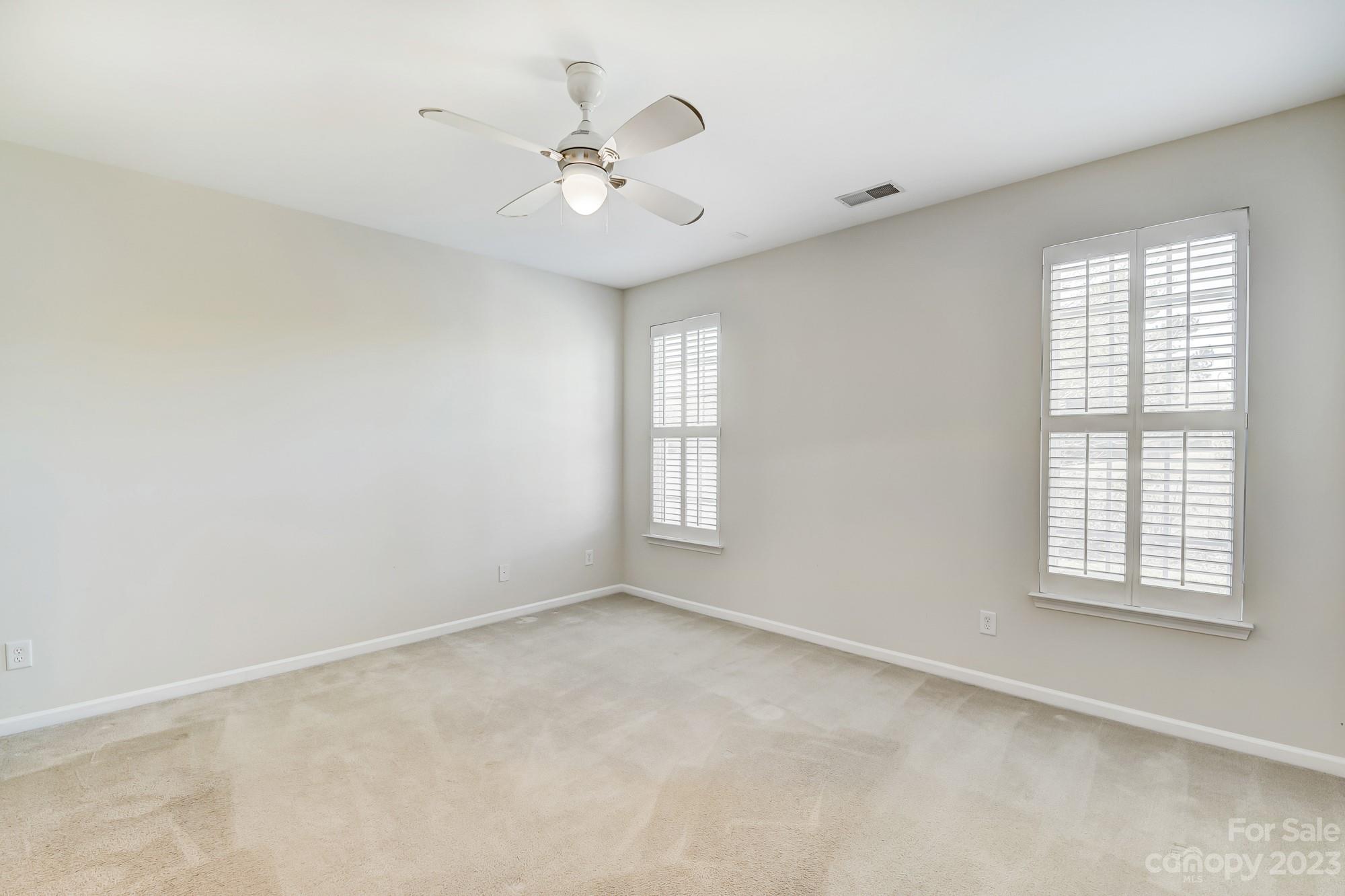 3253 Sapphire Lane Fort Mill, SC 29708 - Photo 20 of 35 an empty room with windows and fan