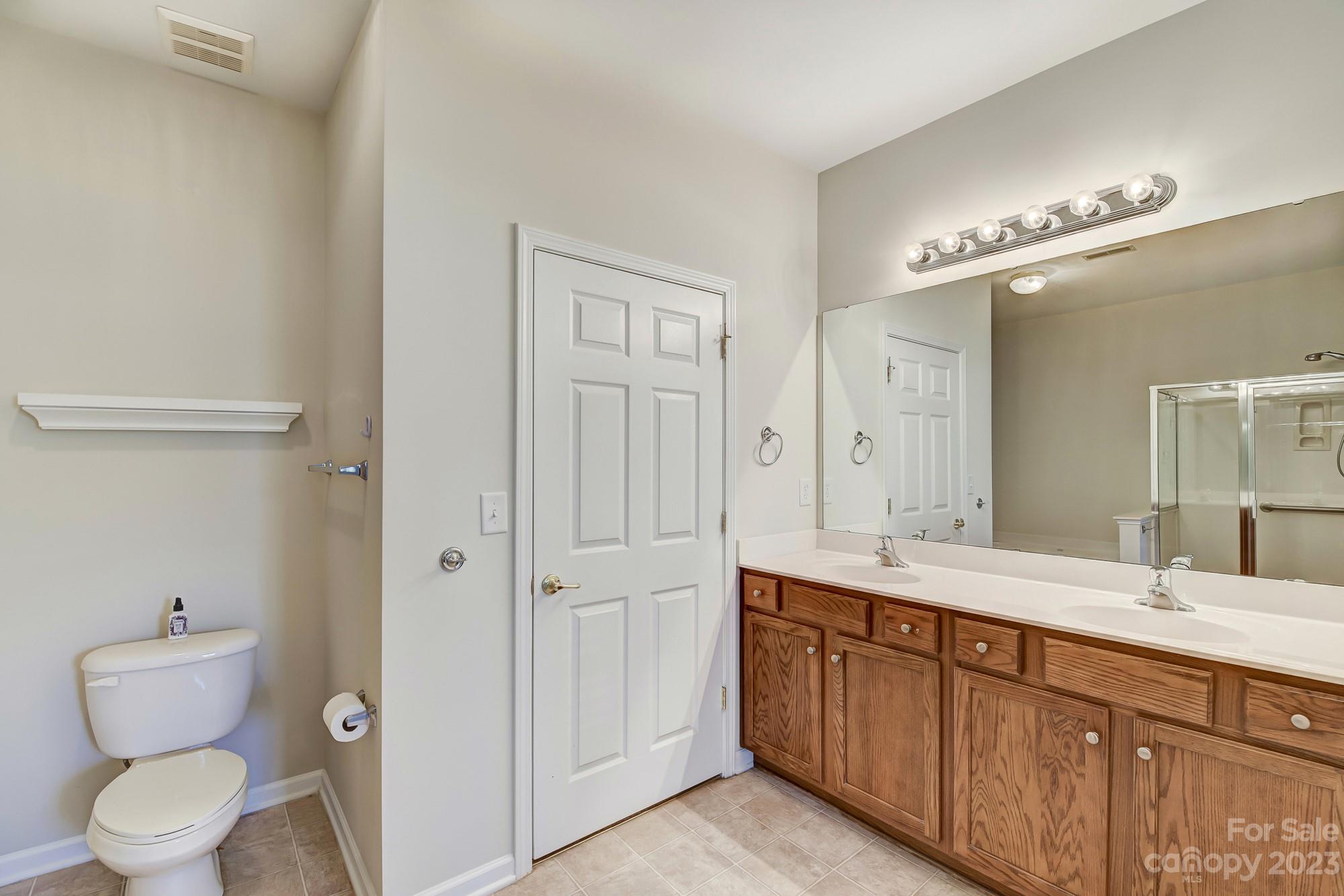 3253 Sapphire Lane Fort Mill, SC 29708 - Photo 23 of 35 a bathroom with a granite countertop sink a toilet and a mirror