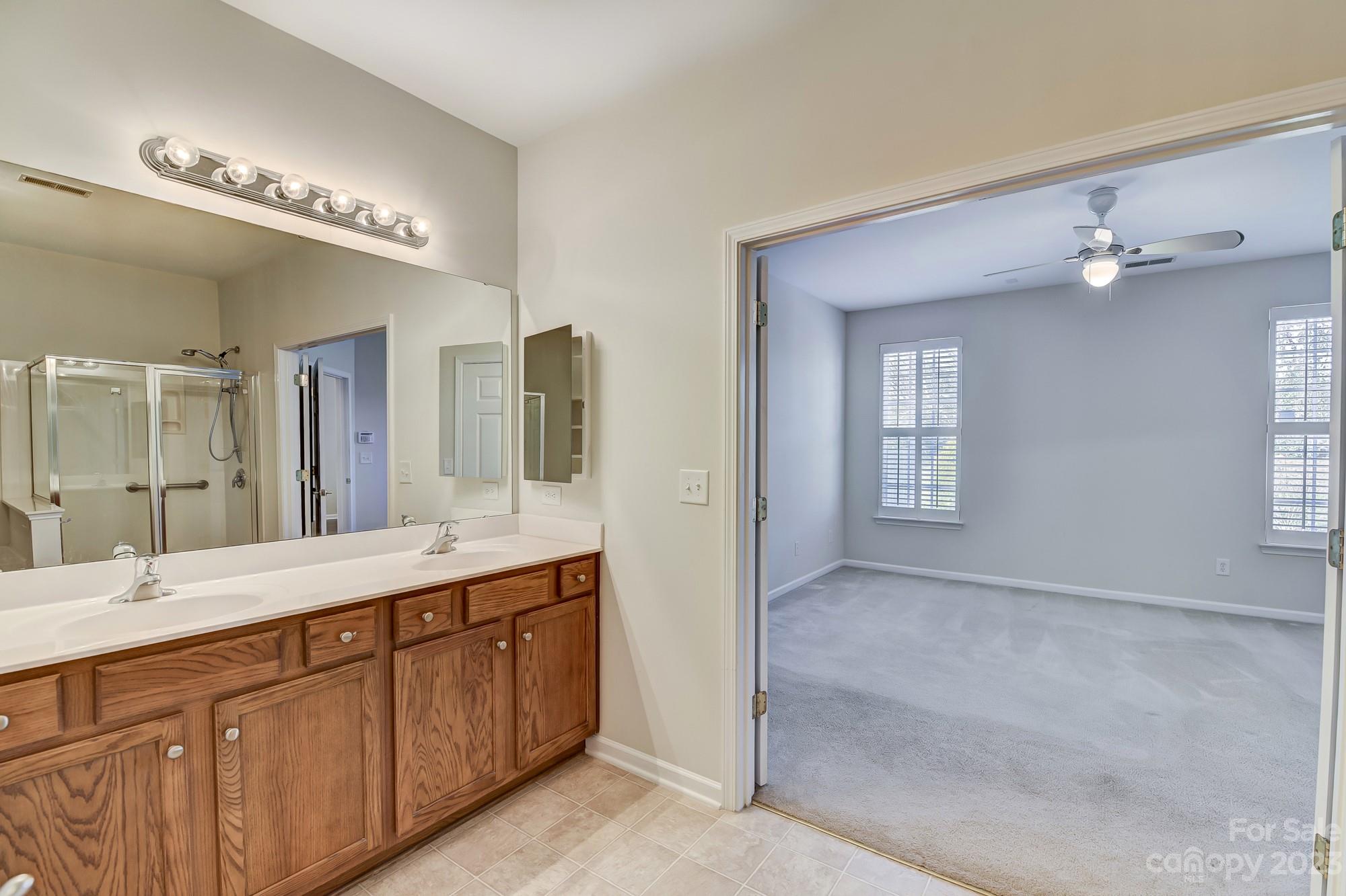3253 Sapphire Lane Fort Mill, SC 29708 - Photo 26 of 35 a spacious bathroom with a double vanity sink a mirror and a shower