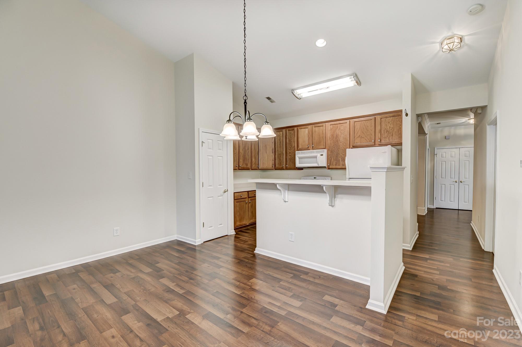 3253 Sapphire Lane Fort Mill, SC 29708 - Photo 5 of 35 a view of a kitchen with a sink wooden floor and a kitchen