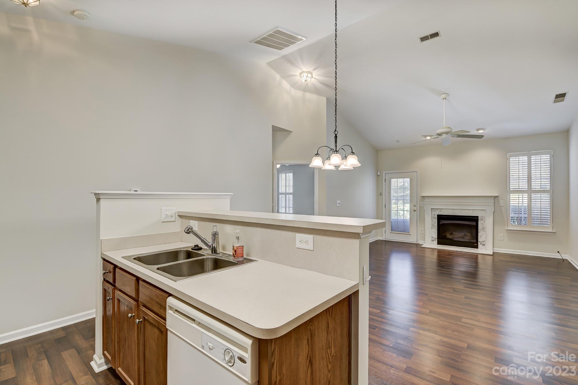 3253 Sapphire Lane Fort Mill, SC 29708 - Photo 7 of 35 a kitchen with a stove a sink and a fireplace