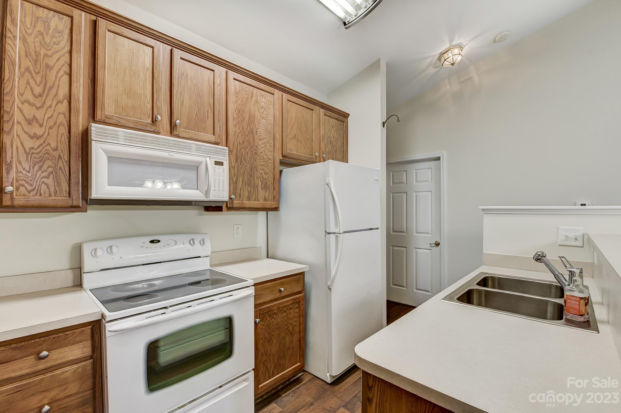 3253 Sapphire Lane Fort Mill, SC 29708 - Photo 8 of 35 a kitchen with a stove a refrigerator and a sink