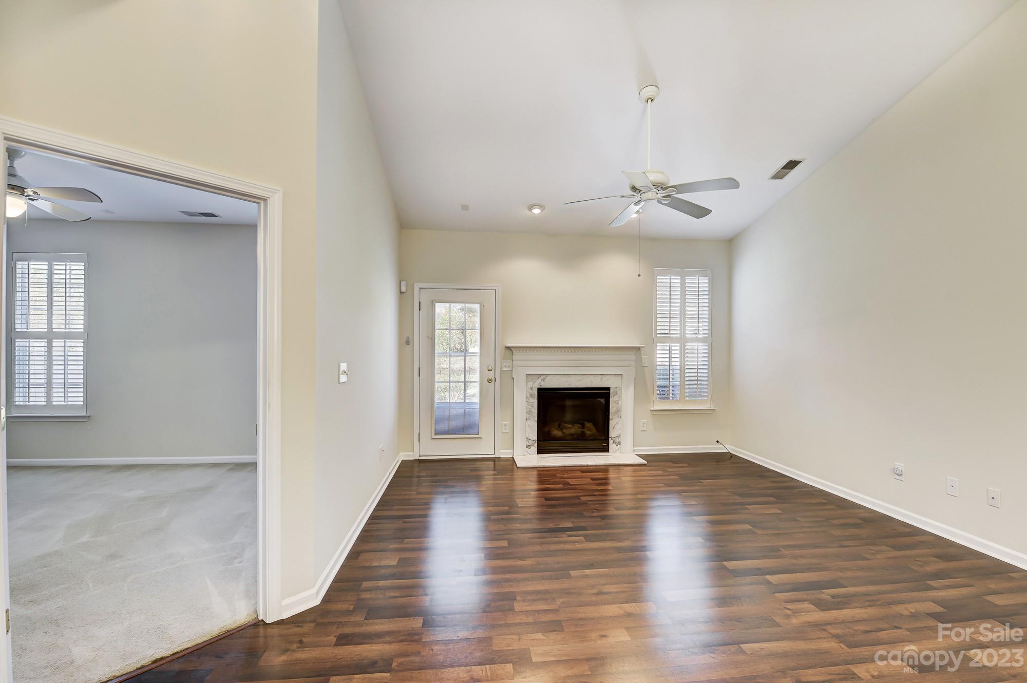 3253 Sapphire Lane Fort Mill, SC 29708 - Photo 10 of 35 a view of empty room with wooden floor fireplace and windows